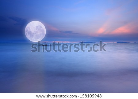 Full moon over blue sea and sky ,Long exposure technique