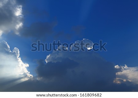 Sun break through the big rainy cloud