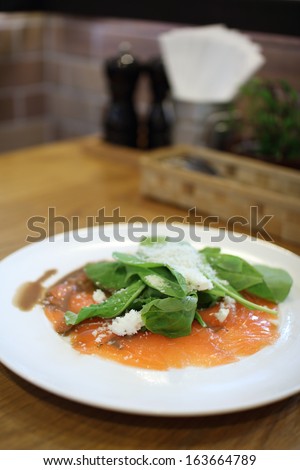 Fresh rocket green salad with salted salmon, selective focus