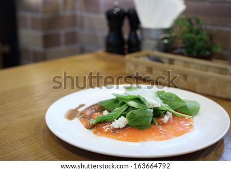 Fresh rocket green salad with salted salmon, selective focus