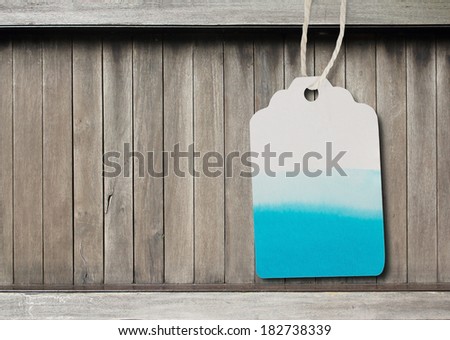 Blue watercolor  label  paper  on  brown wood background