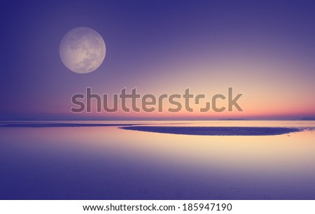 Full moon over blue sea and sky ,Long exposure technique