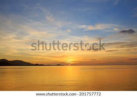 Dramatic golden beach sunset sky and tropical sea background