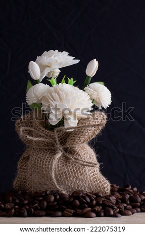 Jasmine flowers made from soap with burlap sack on black background