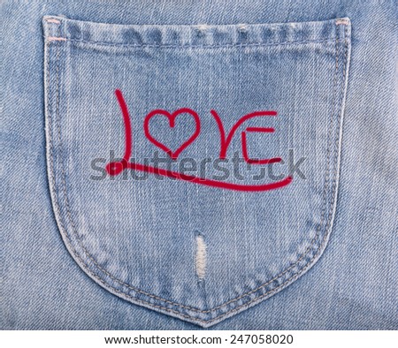 Love text on denim blue jeans background
