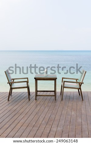 Wooden vintage table set with blue sky and sea background
