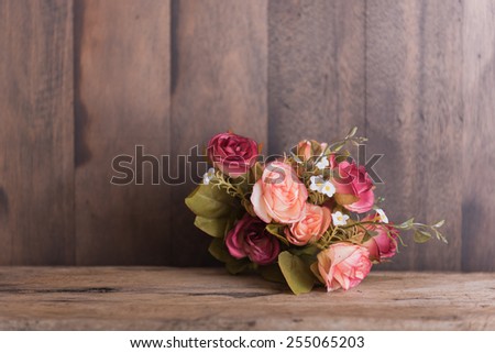 Vintage rose bouquet on wood background