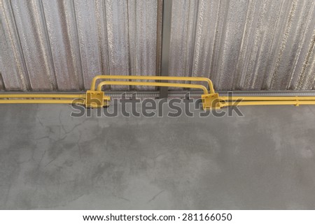 Yellow PVC pipes for electrical boxes and wires buried on concrete wall background
