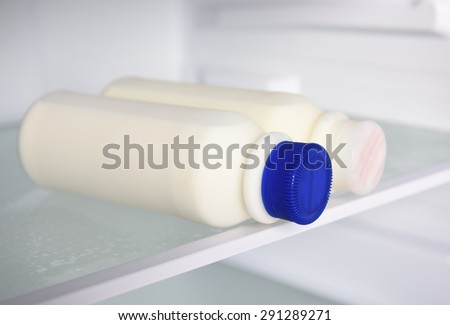 Milk bottles in refrigerator