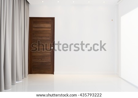 Beautiful modern   living room decor with wooden door and grey curtain background
