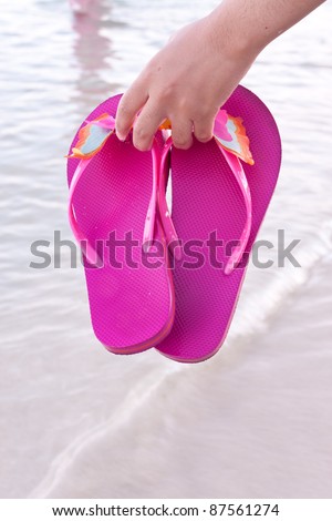 young woman on the beach with flip flop