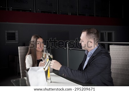 young couple drinking champagne and toasting