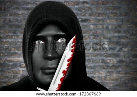 Masked murderer with knife and hooded sweat shirt