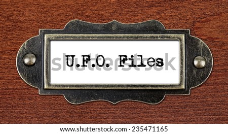 ufo files - file cabinet label, bronze holder against grunge and scratched wood