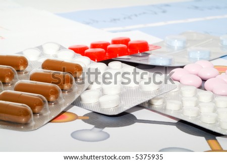 Tablets on a background of medical diagrams.