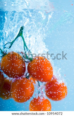 cherry are falling in water with a big splash