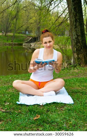 girl student reading book in  park