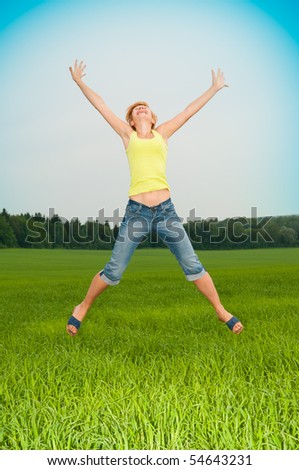 young woman jumps in the field