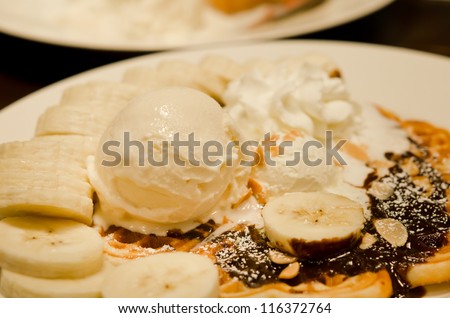 vanilla ice cream waffle with bananas and whipping cream