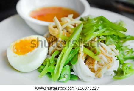 rice vermicelli served with boiled egg,  vegetable  and sweet sauce