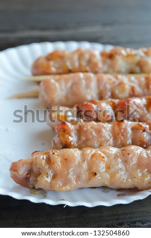 grilled pork  marinated  sweet sauce  on white paper plate