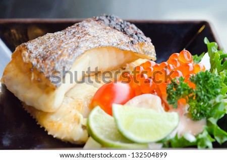 fresh salad with fish egg  and Japanese grilled cod fish  on plate