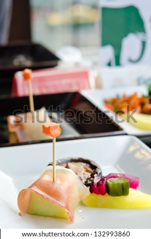 Salmon and fruit sticks with  melon and mixed pickled vegetable