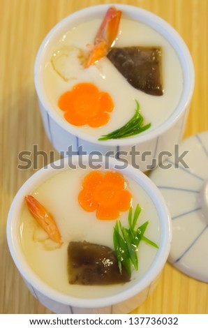 top view of  Chinese steam egg  in white bowl on wooden background