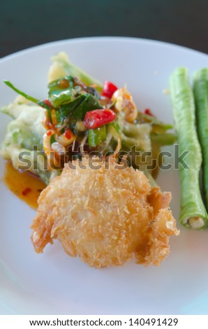 close up crispy shrimp and crispy vegetable served with chili sauce and fresh vegetable on white plate
