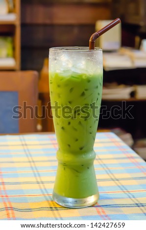 iced milk  green tea with straw  on table