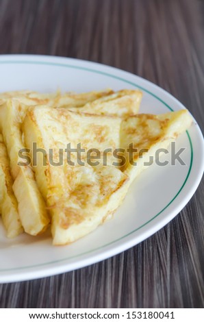 slices of french toast with  on a white plate
