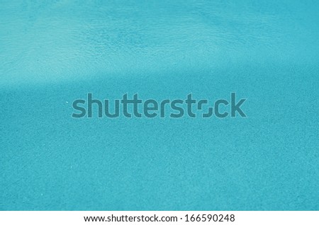 Blue Sandy beach background. Detailed sand texture and water . Top view