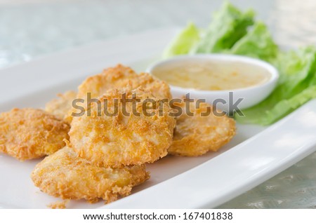 Thai Food Fried Fish Cake (Tod Mun Pla) served with sweet sauce and fresh lettuce