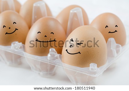 happy  brown egg in  the package on white background