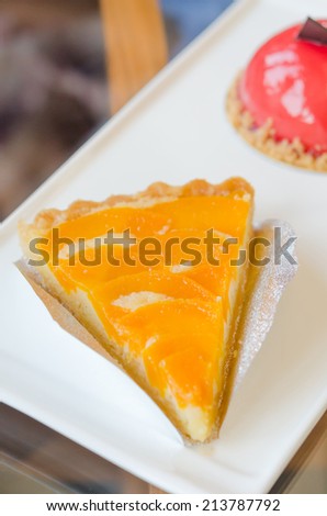 piece of peach tart on dish  , fruit dessert