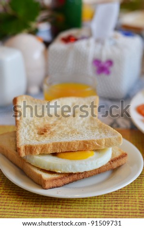 breakfast , fried egg sandwich on buttered toast