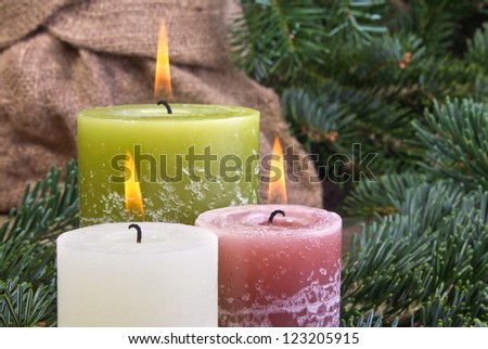 three candles on wooden ground/candles/christmas