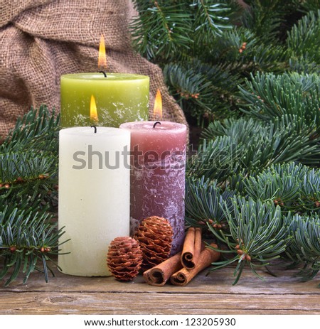 three candles on wooden ground/candles/christmas
