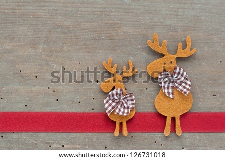 red tape and brown reindeer on wooden ground/christmas/reindeer