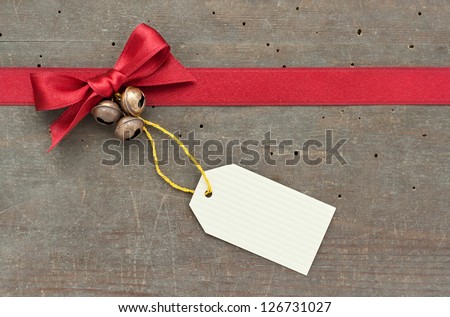 red loop, label and bells on wooden ground/christmas/loop