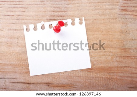 White note and pin on wooden ground/note/pin