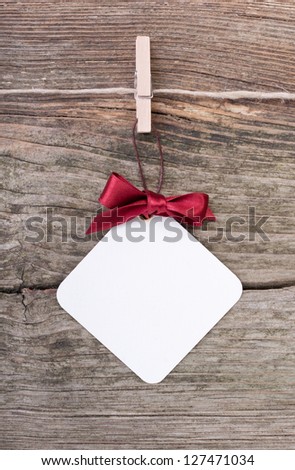 label and red loop on wooden ground/christmas/label