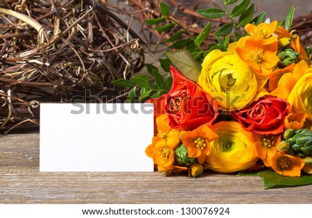 flowers and white card on wooden ground/flowers/spring