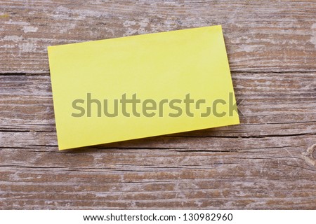 yellow note on wooden ground/note/background