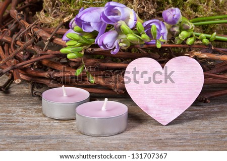 Freesias, heart, candles, twigs and moss/heart/valentine`s day