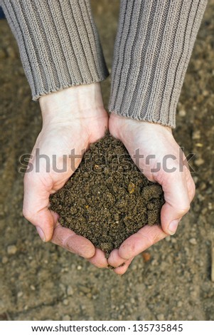 hands with garden soil/gardening/garden soil