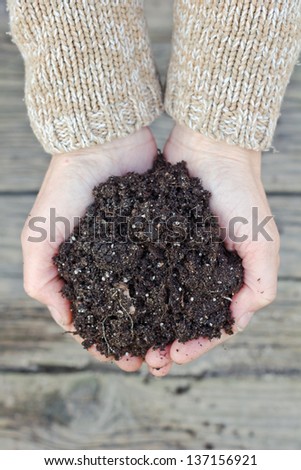 hands with garden soil/gardening/garden soil