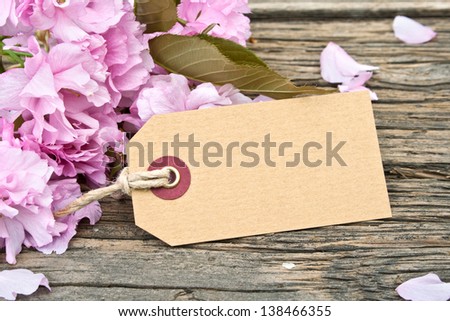 pink blossoms label on wooden ground/flowers/blossoms