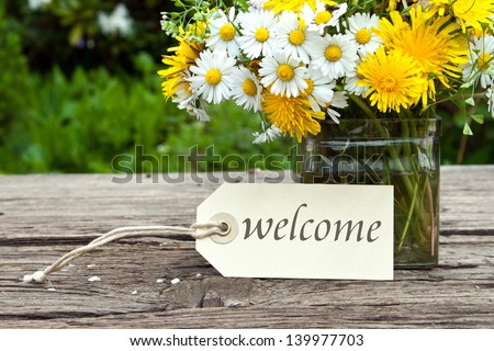 wild flowers and label with lettering welcome/wild flowers/spring