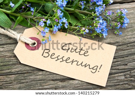 blue flowers and  label with lettering get well/spring/flowers